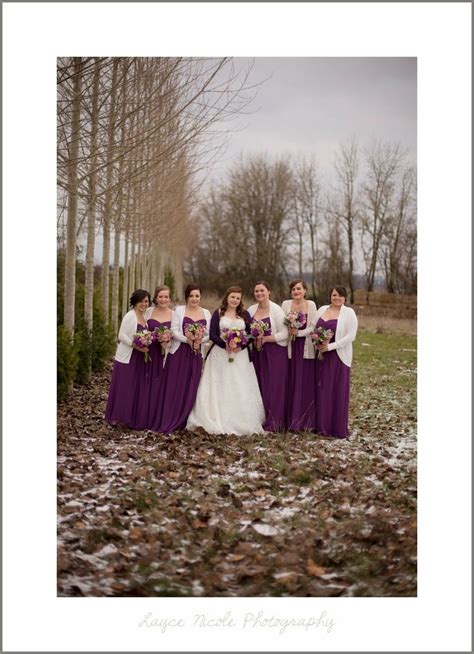 Winter barn wedding. Purple bridesmaids in white cardigans. Bride in ...