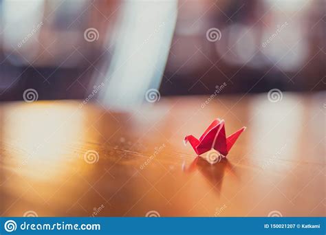 Tiny Red Origami Crane on Table Stock Image - Image of colorful, paper ...