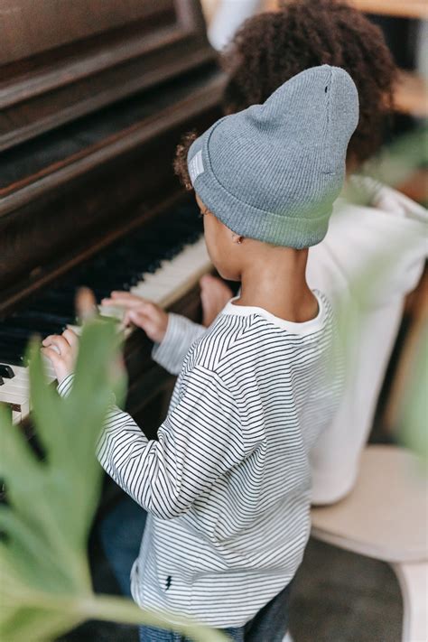 Anonymous black kids playing piano at home · Free Stock Photo