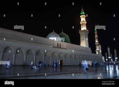 Masjid Nabawi at night time. People walking at night at the Prophet's ...