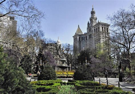 a large building with many trees and bushes in the foreground on a ...