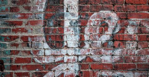 Red Brick Wall with an Old Graffiti · Free Stock Photo