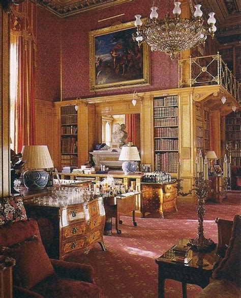 the room is full of antique furniture and bookshelves, with chandeliers ...