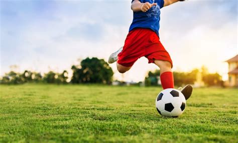 Premium Photo | An action sport picture of kid playing soccer football ...