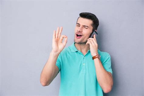 Happy Young Man Talking On The Phone Stock Photo - Image of cute, sign ...