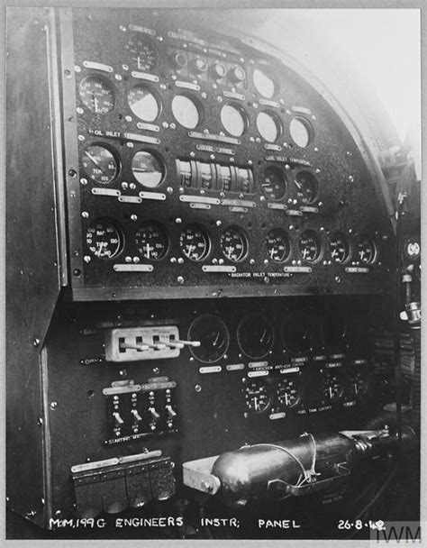 INSIDE A HALIFAX AIRCRAFT OF BOMBER COMMAND; THE ENGINEER SEATED AT THE ...