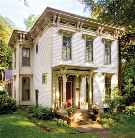 a large white house sitting on top of a lush green field