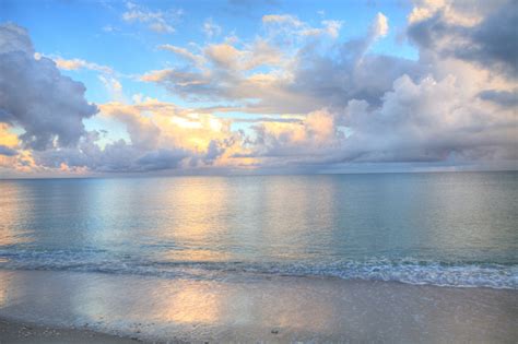 Ocean Rolls In Under Puffy Clouds On North Naples Beach Stock Photo ...