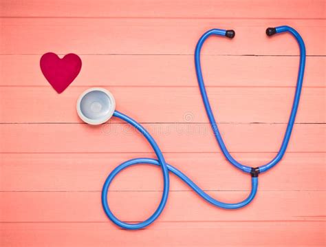 Stethoscope and Heart on Pastel Pink Wooden Table. Cardiology Equipment ...