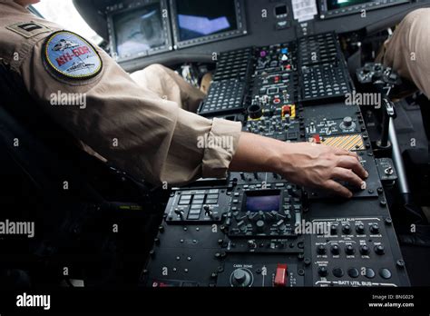 US Navy pilots sit in the cockpit of a Sikorsky MH-60R helicopter at ...