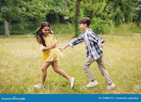 Two kids running in park. stock photo. Image of people - 124882772