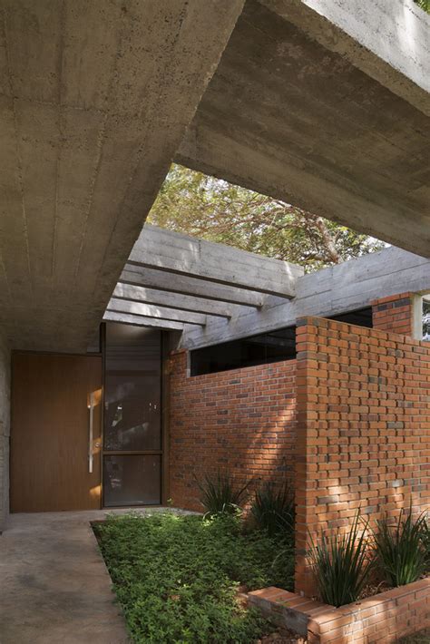 Concrete roof slabs and surfaces freely fly over this brick house in ...