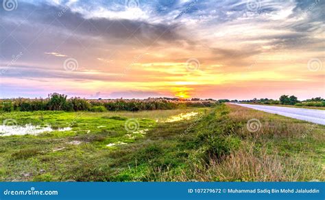 A Sunset View with the Scenic Green Landscape at Highway Road Stock ...