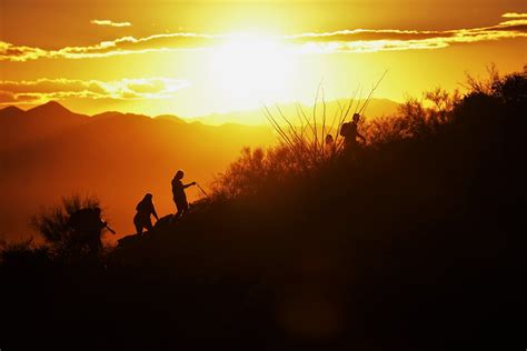 Silhouettes of People Hiking at Sunset · Free Stock Photo