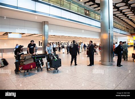 People at international arrivals Heathrow airport London England UK ...