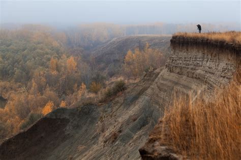 Premium Photo | A lone photographer at the edge of a cliff