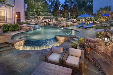 Infinity edge pool with boulder waterfall and spa. | Backyard pool ...