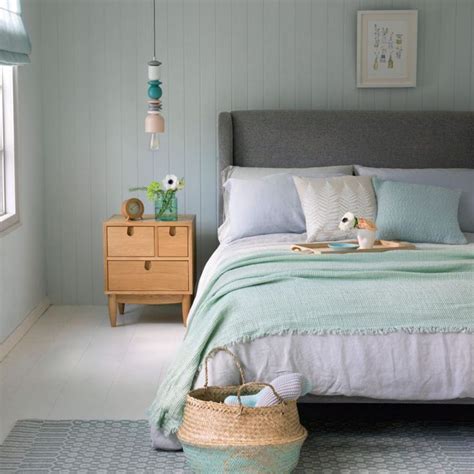 Mint bedroom with upholstered grey bed and white wood flooring | Ideal ...