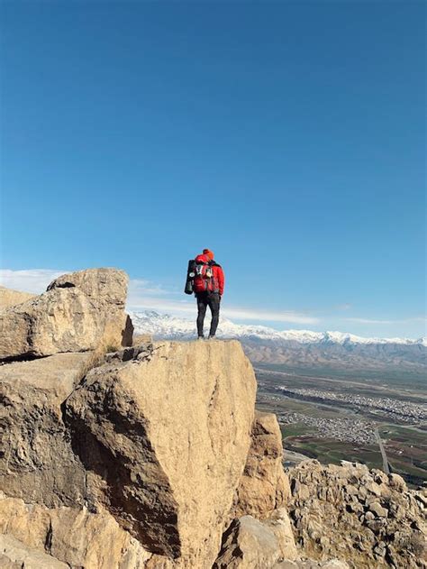 A Hiker on the Edge of a Cliff · Free Stock Photo