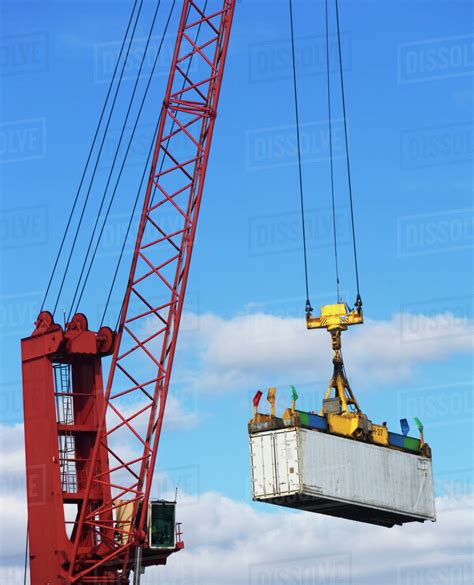 Crane lifting a shipping container - Stock Photo - Dissolve