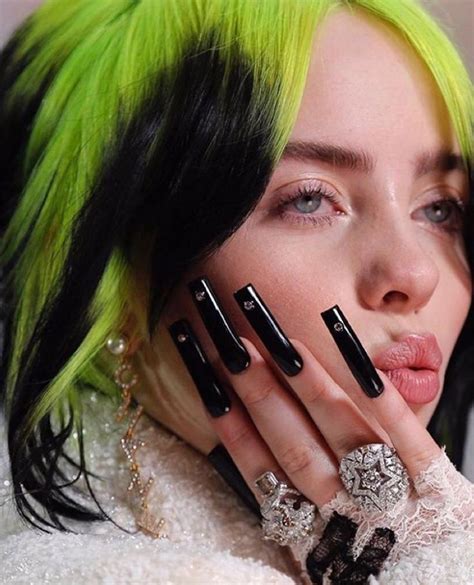 a woman with bright green hair and black nails