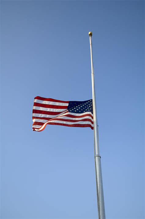 The American Flag At Half Staff Due Photograph by Joel Sartore