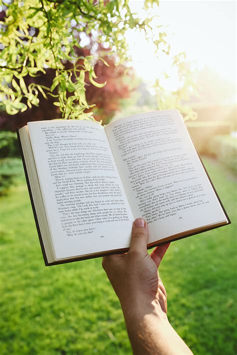 Royalty-Free photo: Man reading a book outdoors | PickPik