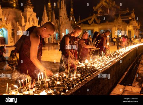 Group of Monks lighting candles in Shwedagon Pagoda for Thadingyut ...