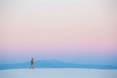 Download Minimalist Desktop Man Walking On Sand Wallpaper | Wallpapers.com