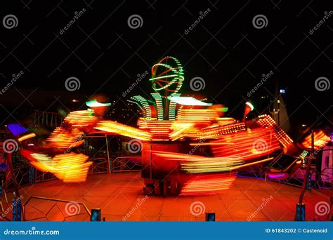 Carousels at night editorial photography. Image of orange - 61843202