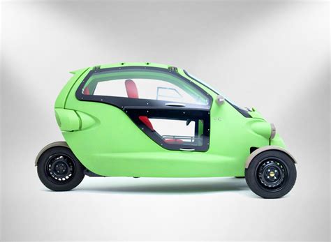 sam is a bug-eyed three-wheeled two-person electric vehicle