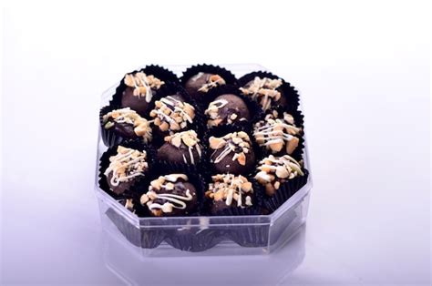 Premium Photo | A box of chocolate truffles with nuts in it