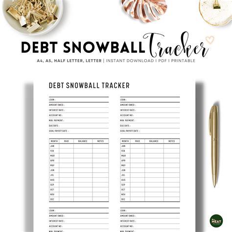 the debt snowball tracker is shown on top of a table with gold ...