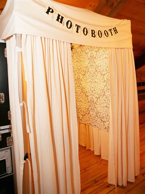 a photo booth set up with white drapes