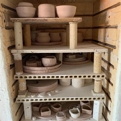 the shelves are filled with different types of bowls and plates in ...