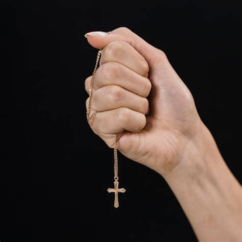 Free Photo | Female hand holding cross necklace