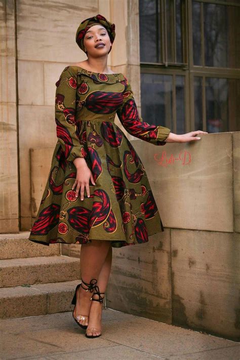 a woman in a dress is standing on some steps and posing for the camera ...