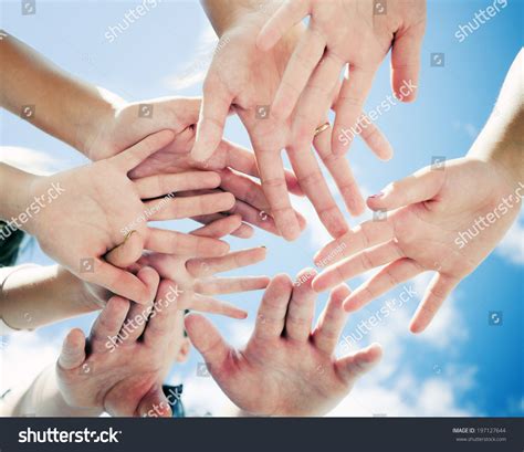 A Group Of People With Their Hands All In The Middle. Stock Photo ...