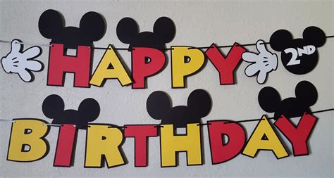 mickey mouse happy birthday banner hanging on a wall