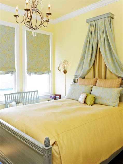 A traditional, French-inspired yellow and gray/blue bedroom with a bed ...