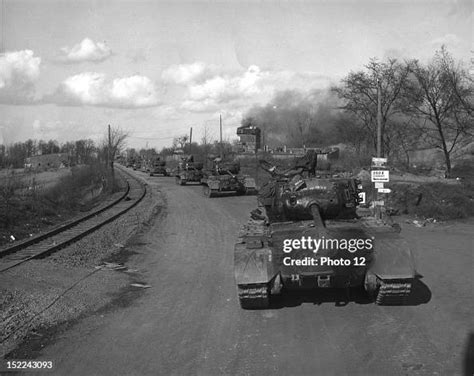 A convoy of US General Pershing tanks moves through a blasted German ...