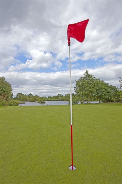 Golf Green with Red Golf Flag Stock Photo - Image of luxury, clouds ...