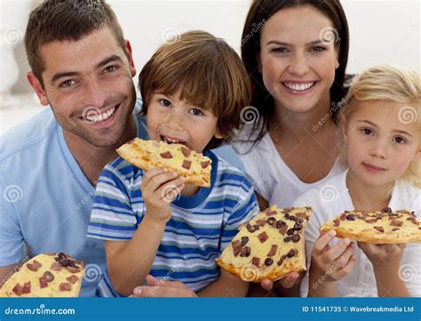 Portrait of Family Eating Pizza in Living-room Stock Image - Image of ...