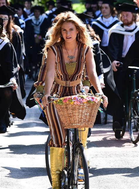 Lily James rocks a striped jumpsuit and gold platform boots as she ...