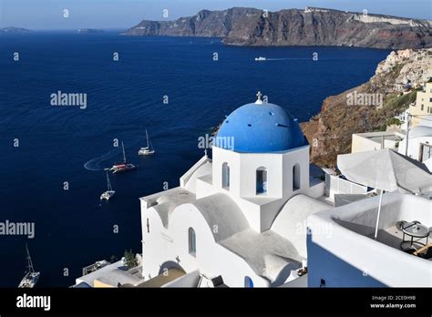 Santorini and its white houses with blue roofs Stock Photo - Alamy