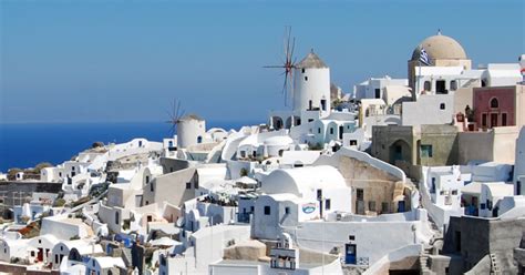 Why are most houses white painted in Santorini?