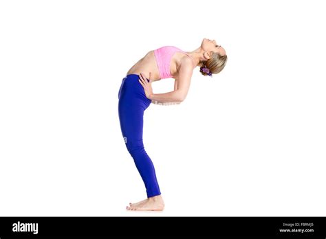 Sporty beautiful young blond woman doing Standing Backward Bend yoga ...