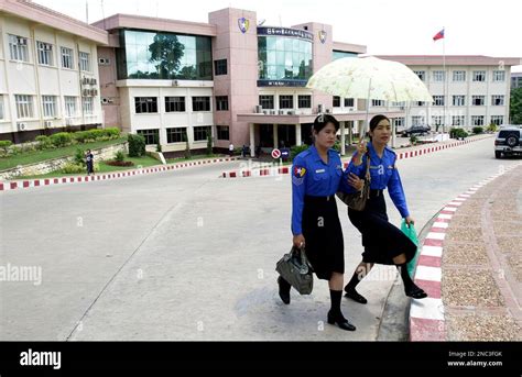 In this photo taken June 26, 2010, two Myanmar policewomen walk outside ...