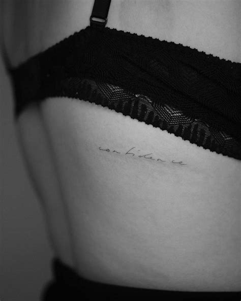 Tattoo of the word "confidence" located on the back.