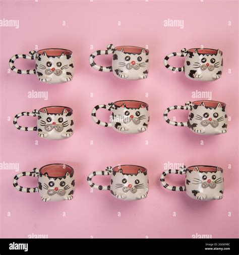 cat figured coffee cups on pink background Stock Photo - Alamy